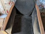 a chair that is made out of wood and has a seat made out of fabric
