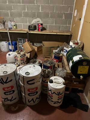 a room with a bunch of barrels and cans on the floor