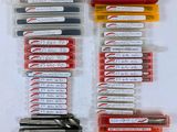 a lot of pens that are sitting on a table