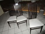 four chairs that are sitting on a tile floor