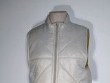 a white vest on a mannequin with a yellow zipper