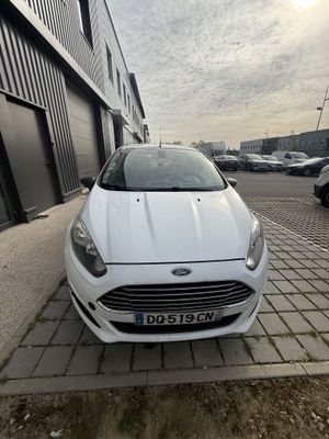 the white car is parked on the side of the road