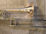 a trumpet and a trombone sitting on the floor
