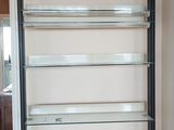 a white book shelf with drawers in a living room