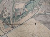 an old map of a city on the wall
