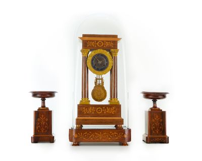 a clock that is sitting under a glass dome