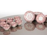 a lot of pink and white plates sitting on a table