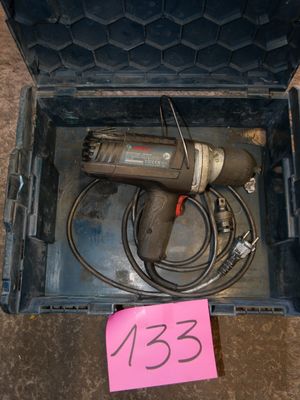 a tool in a case with a pink sticker on it