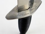 a knife that is sitting on top of a piece of metal