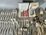 a lot of silverware on a table with a box