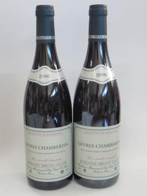 two bottles of wine sitting next to each other on a table