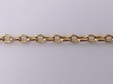 a close up of a gold chain on a white background