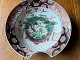 a plate with a bonsai tree on it on a wooden table