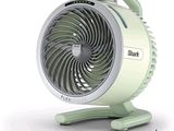 un petit ventilateur posé sur un support, sur une surface blanche