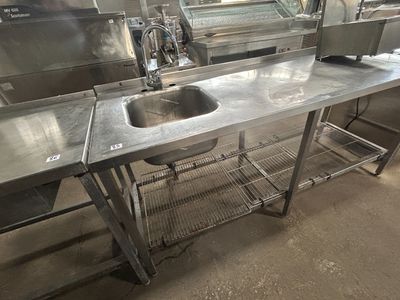 un grand évier en inox au milieu d'une cuisine