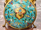 an image of a blue and gold clock sitting on a table