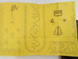 a yellow book with drawings on it on a table