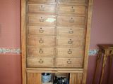 a tall wooden cabinet in the corner of a room