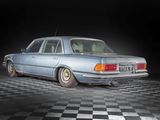a blue car that is parked on a checkered floor