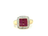 a close up of a gold ring with a ruby stone and diamonds