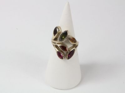 an image of a ring with multi colored stones on it