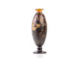 a vase that is sitting on a stand on a white surface