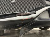 a close up of the front bumper of a black car