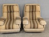 pair of mid century style lounge chairs with striped upholstered cushions