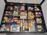 many different types of perfumes in a glass case