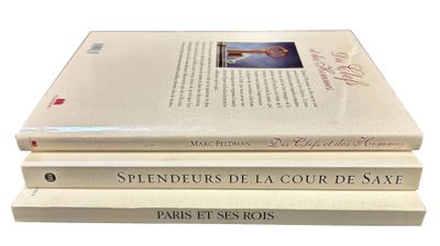 three books stacked on top of each other on a white surface
