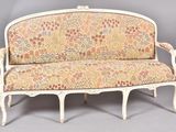 a white couch with a floral upholstered on it