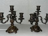 pair of antique brass candelabs on a white background