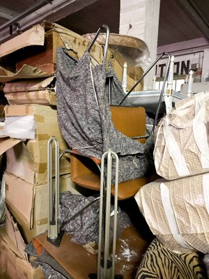 a pile of boxes and a chair in a room