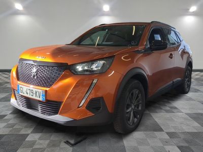 the orange car is parked in the garage on a checkered floor