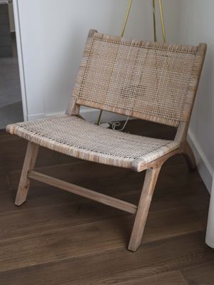a chair that is sitting in a room with a plant in it