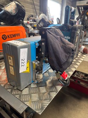 an image of a machine in a factory with a bag on the back of it
