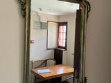 a mirror on the wall reflecting a dining room table