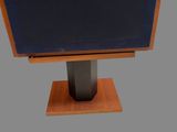 a tv that is on a stand on a gray background