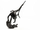 statue of a monkey holding a bird on a white background