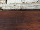 an image of a wooden table with a stone wall in the background