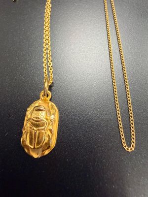 un collier en or orné d'un scarabée égyptien