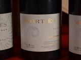 three bottles of wine sitting on top of a table next to each other