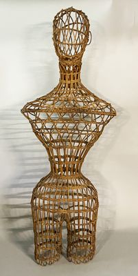 a wicker mannequin with a hat on top of it