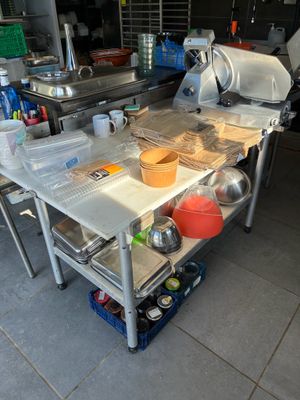 a kitchen with a table that has pots and pans on it