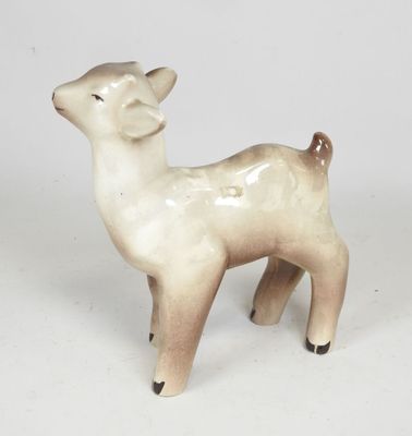 a small ceramic animal that is standing on a white surface