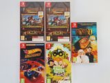 four nintendo wii games on a white surface