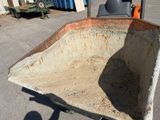 a wheelbarrow that is sitting in the middle of a parking lot