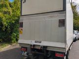un camion blanc garé sur le bord de la route