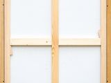 a close up of a wooden window with a white glass pane