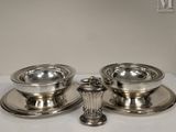 two silver plated candlesticks on a white table